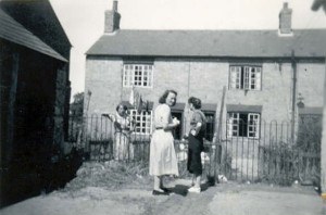 Gladstone Terrace c.1942. Archie Robertson housed his wife and sisters and their children here during the war. There were at least 10 people in the group. The lady in the pale dress was Galdys Withey, ne Robertson.